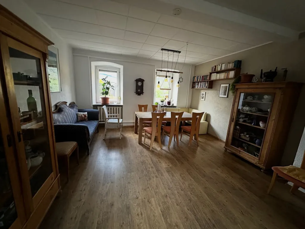 Himmelsscheibe dining and living area with wooden table and cabinet