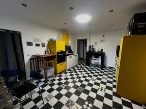 Himmelsscheibe kitchen with checkerboard floor and yellow cabinets