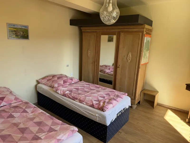 Himmelswege bedroom with single bed and wooden wardrobe