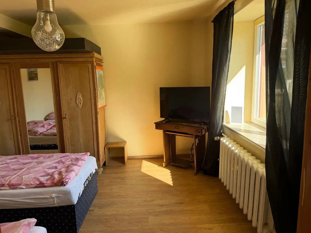 Himmelswege bedroom with TV and window